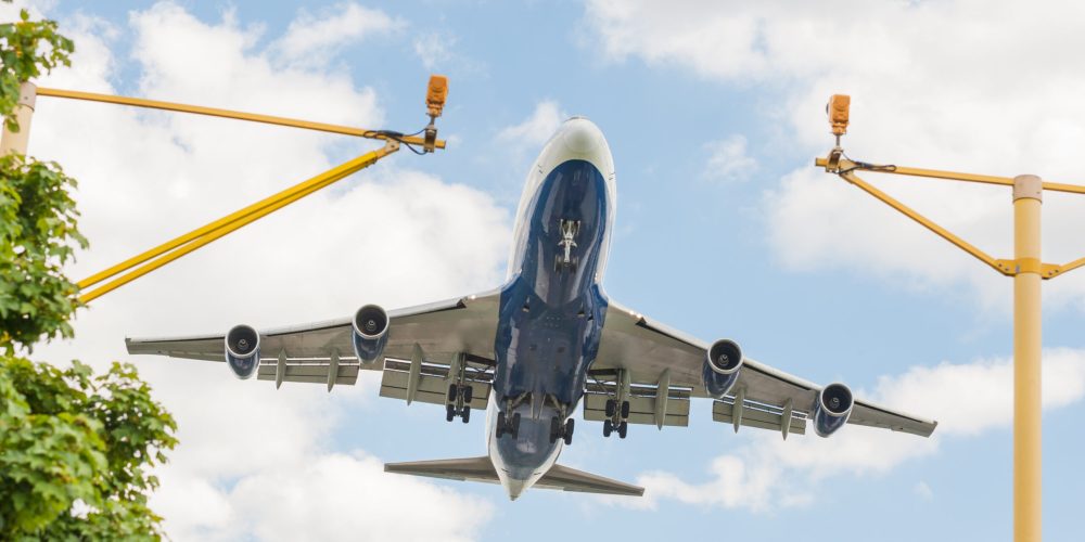 large passenger jet on landing approach to an airport with its undercarriage down